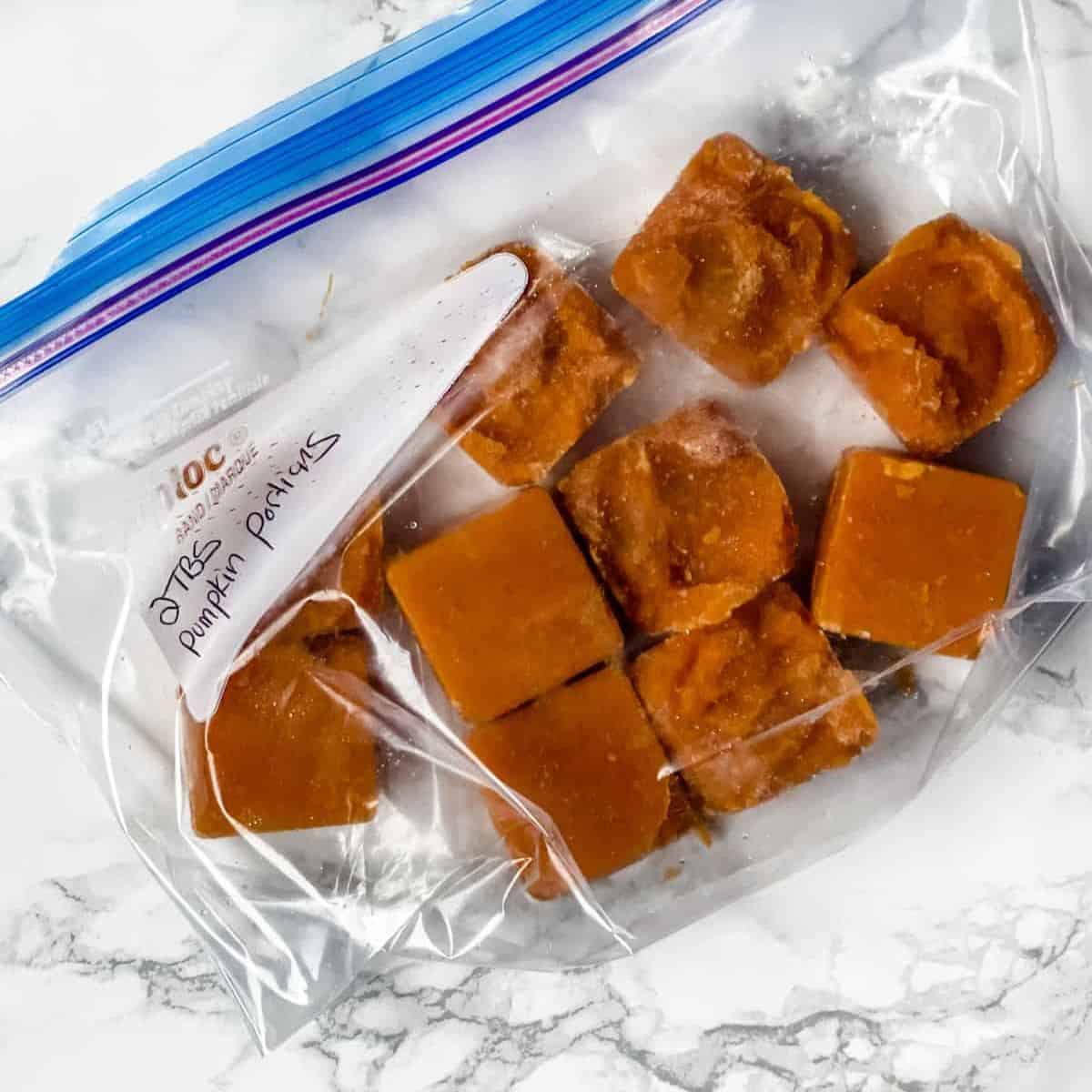 frozen portions of pumpkin in a freezer bag.