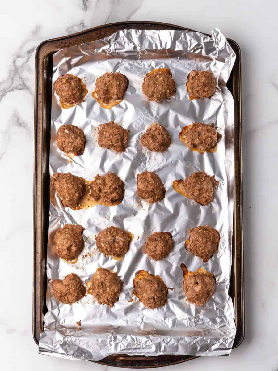 cooked meatballs on a sheet pan.