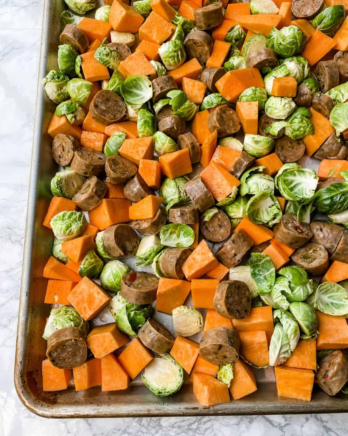 closeup of sausage sweet potato sheet pan ingredients.