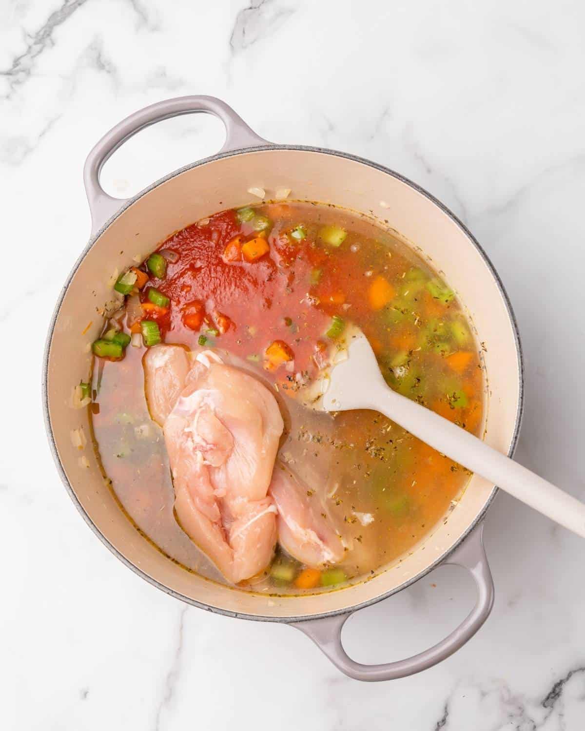 chicken stock tomatoes and chicken to pot