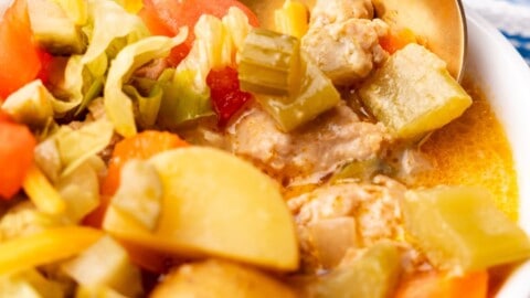 closeup of cheeseburger soup in a bowl with spoon.