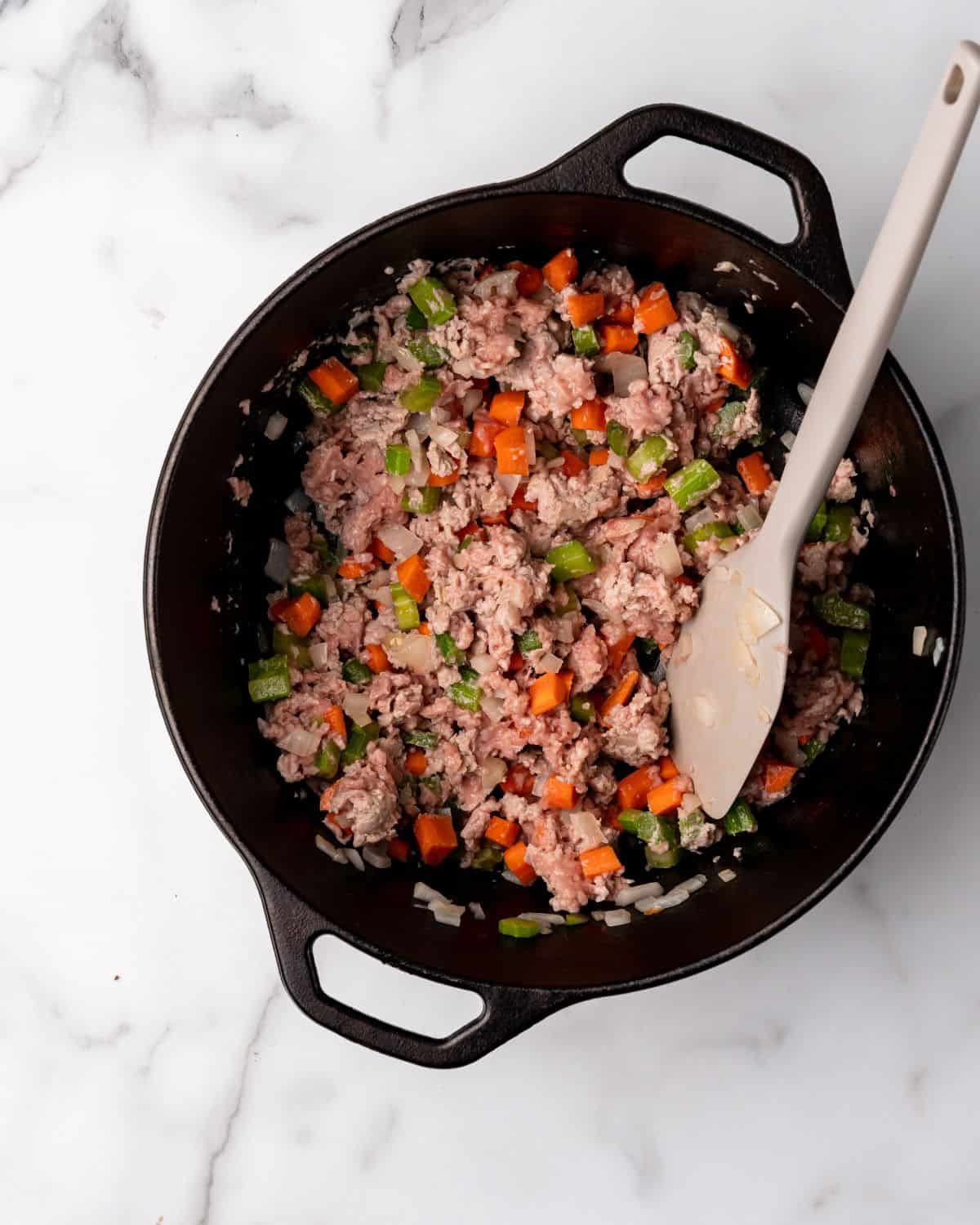 ground turkey cooked with veggies in a soup pot