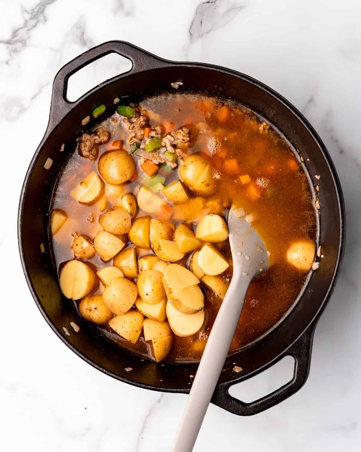 potatoes and stock added to the soup pot.