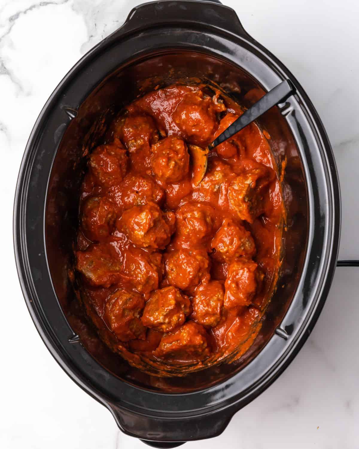 meatballs and sauce in a slow cooker.