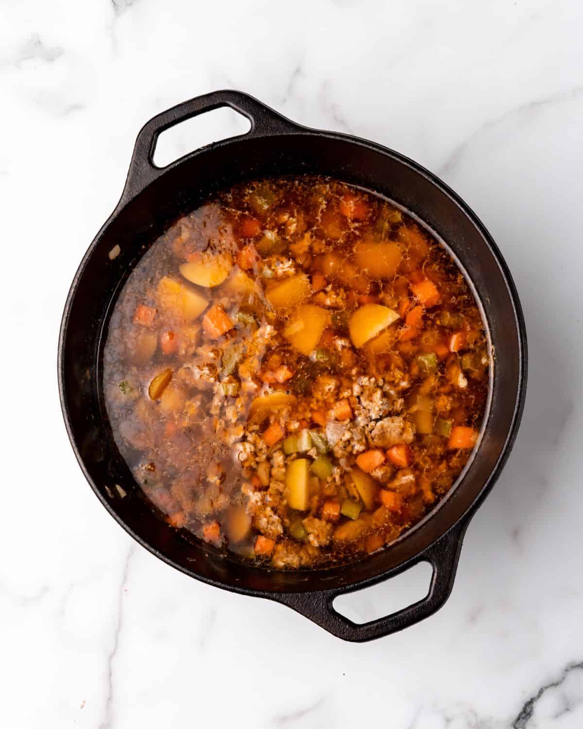 the soup ingredients cooked in a soup pot.