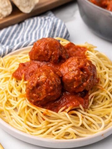 baked turkey meatballs on a plate of pasta.