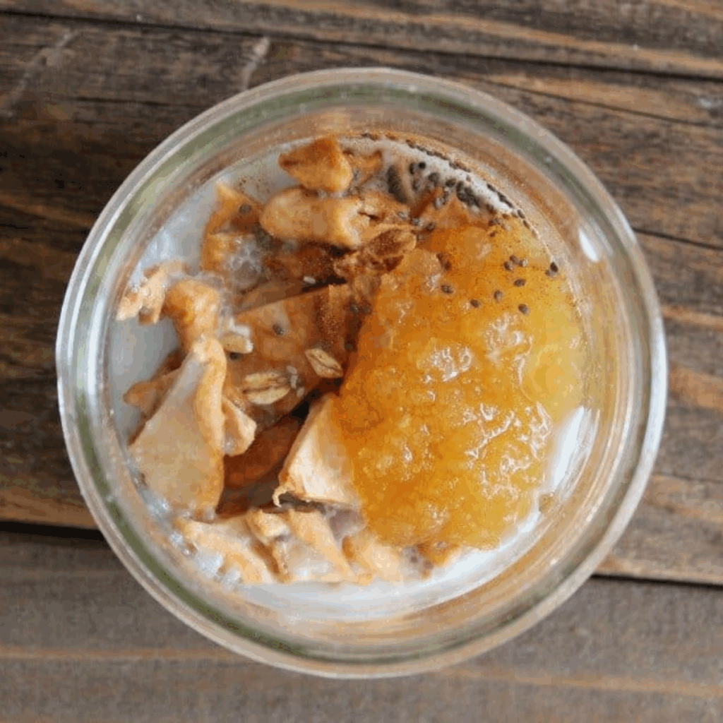 Wet ingredients for apple overnight oats in a jar.