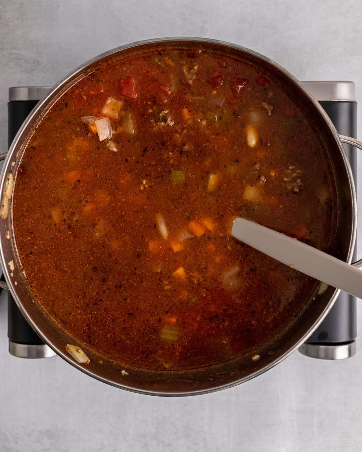 tomato sauce, diced tomato and paste in the pot with the other ingredients.