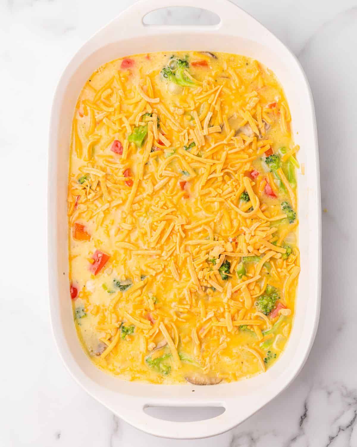 eggs and veggies mixed in a casserole dish.