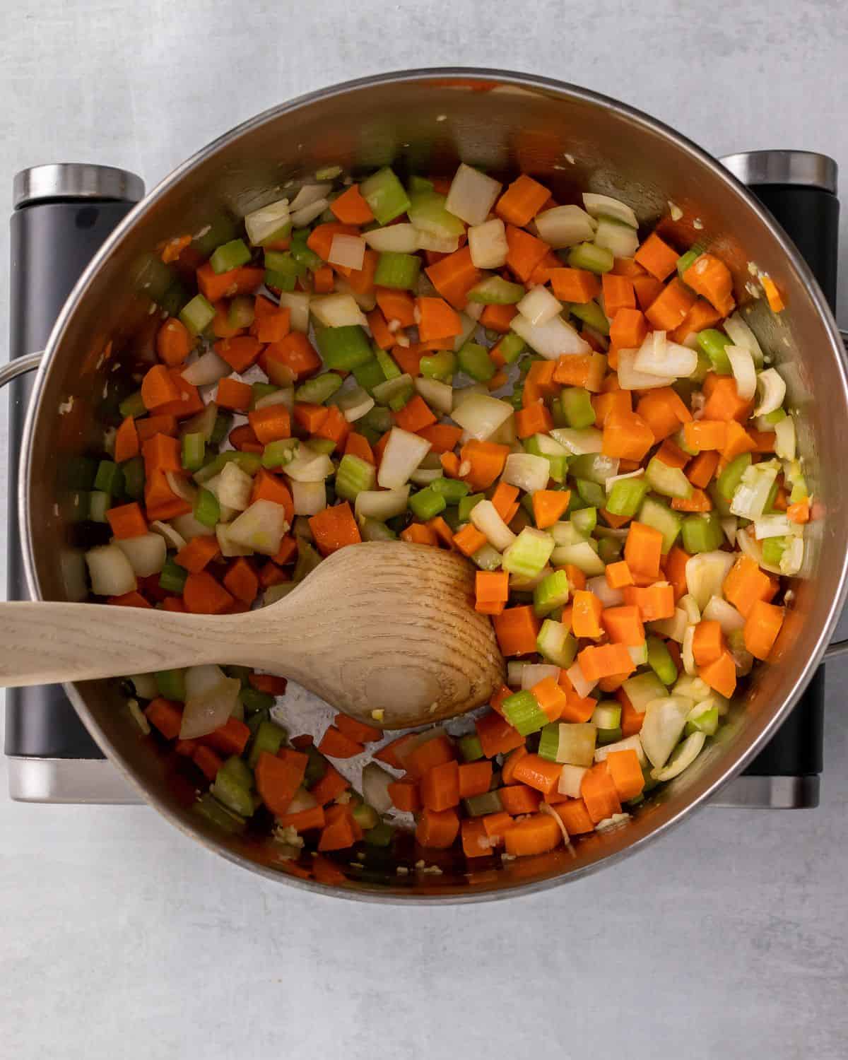 carrots, celery, and onions cooked in a pot.
