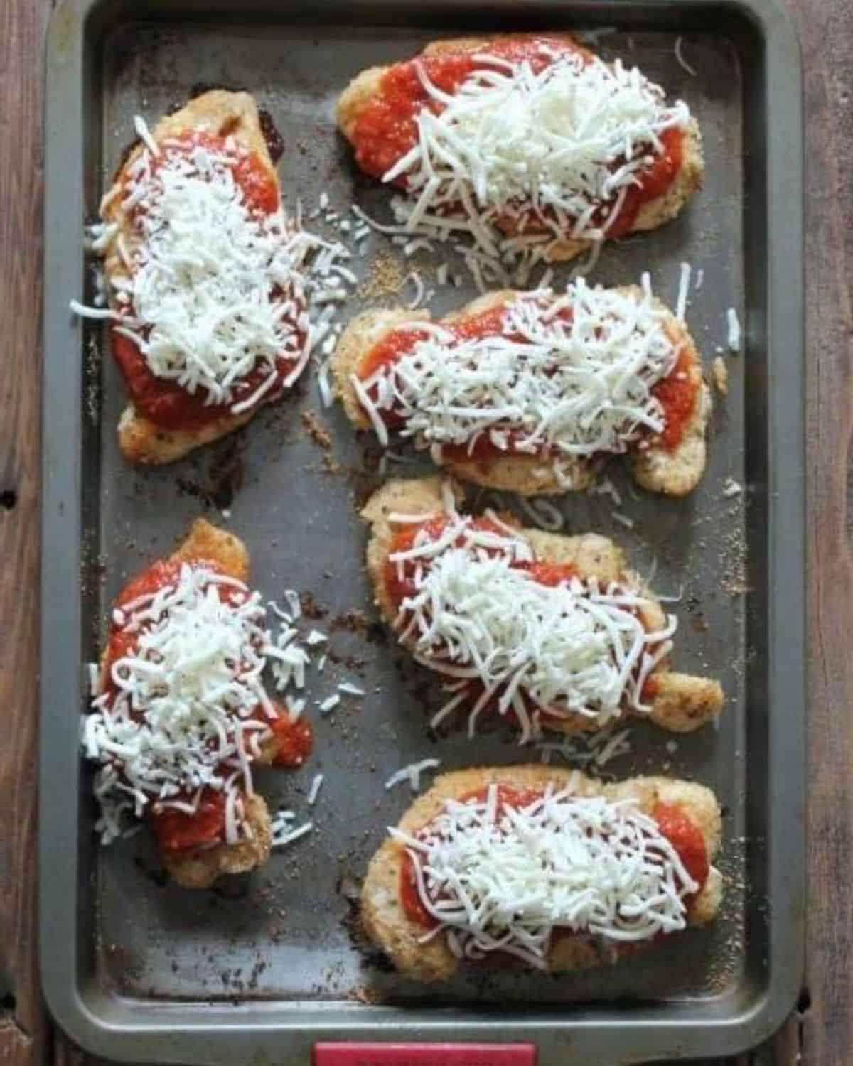 chicken cutlets baked with sauce and cheese added to the top.