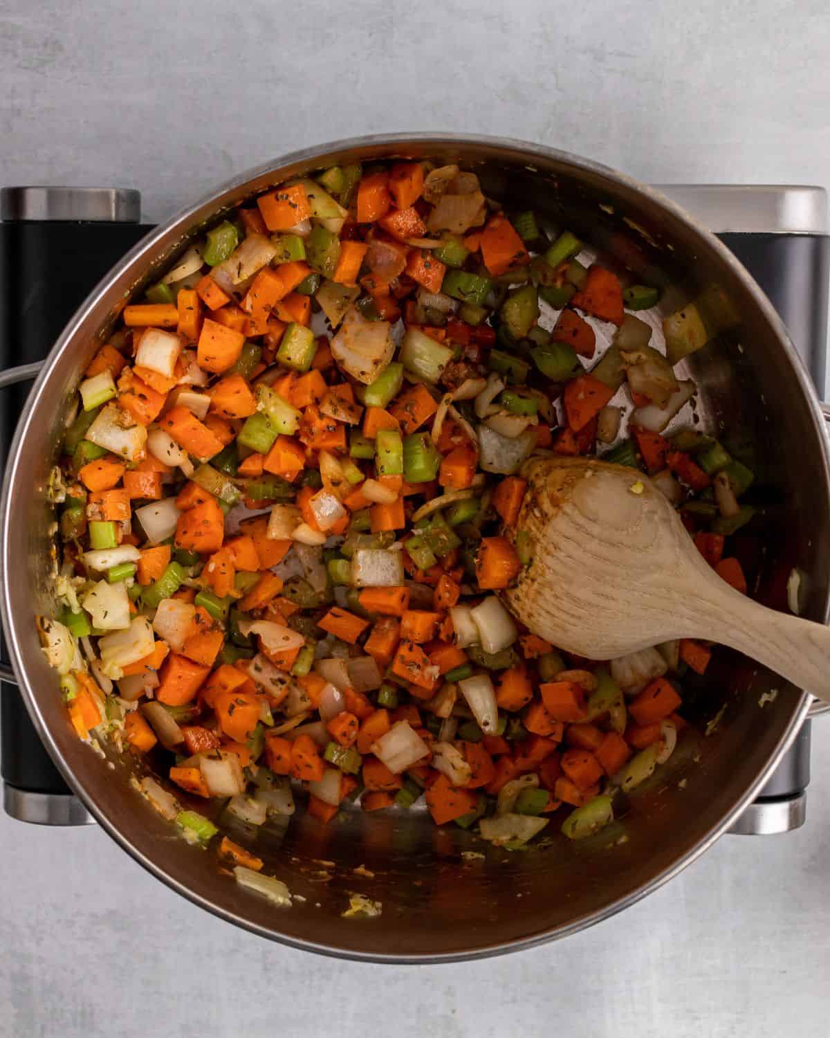 tomato paste stirred into the pot with vegetables.