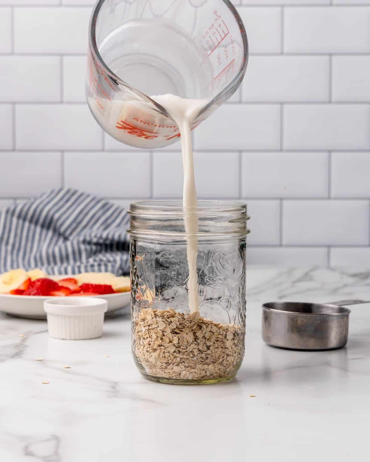 adding milk into a mason jar.