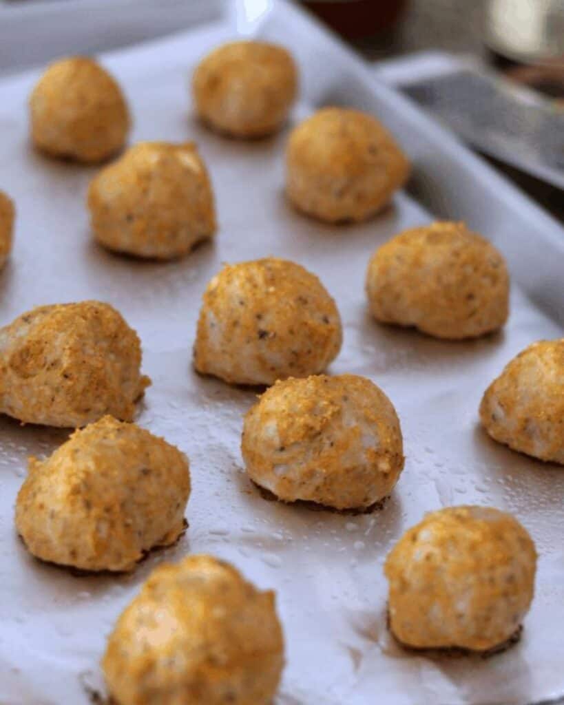 chicken parm meatballs cooked on a baking sheet.