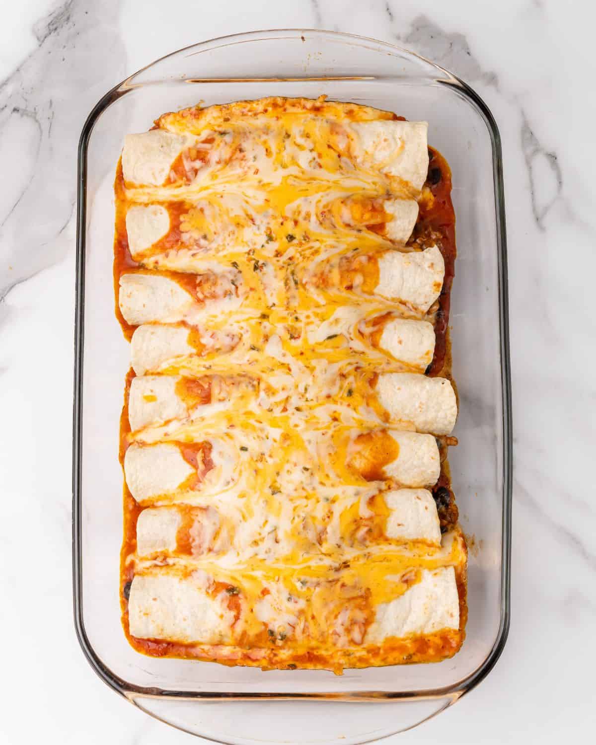 enchiladas cooked in a glass casserole dish.