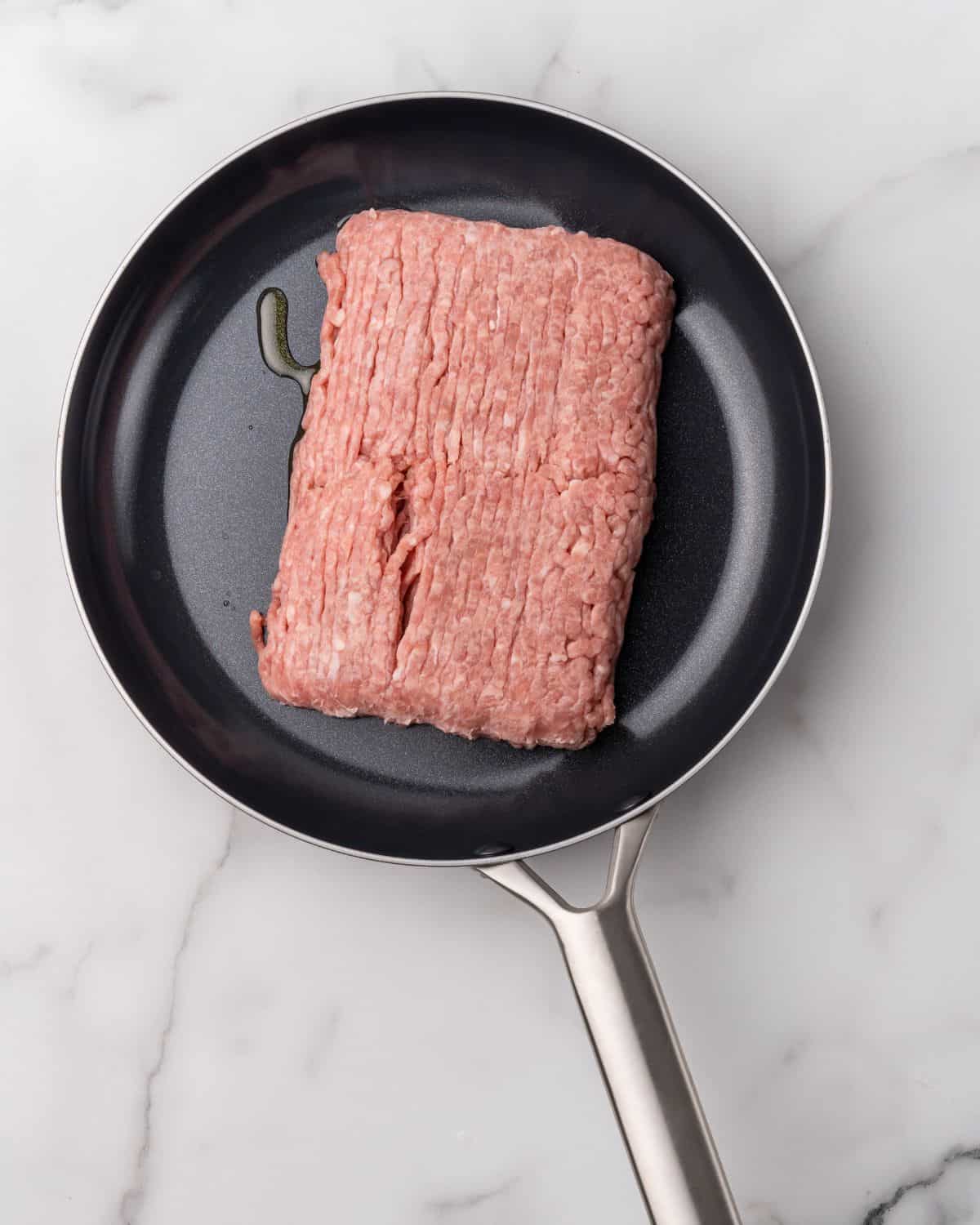 raw ground turkey in a skillet.