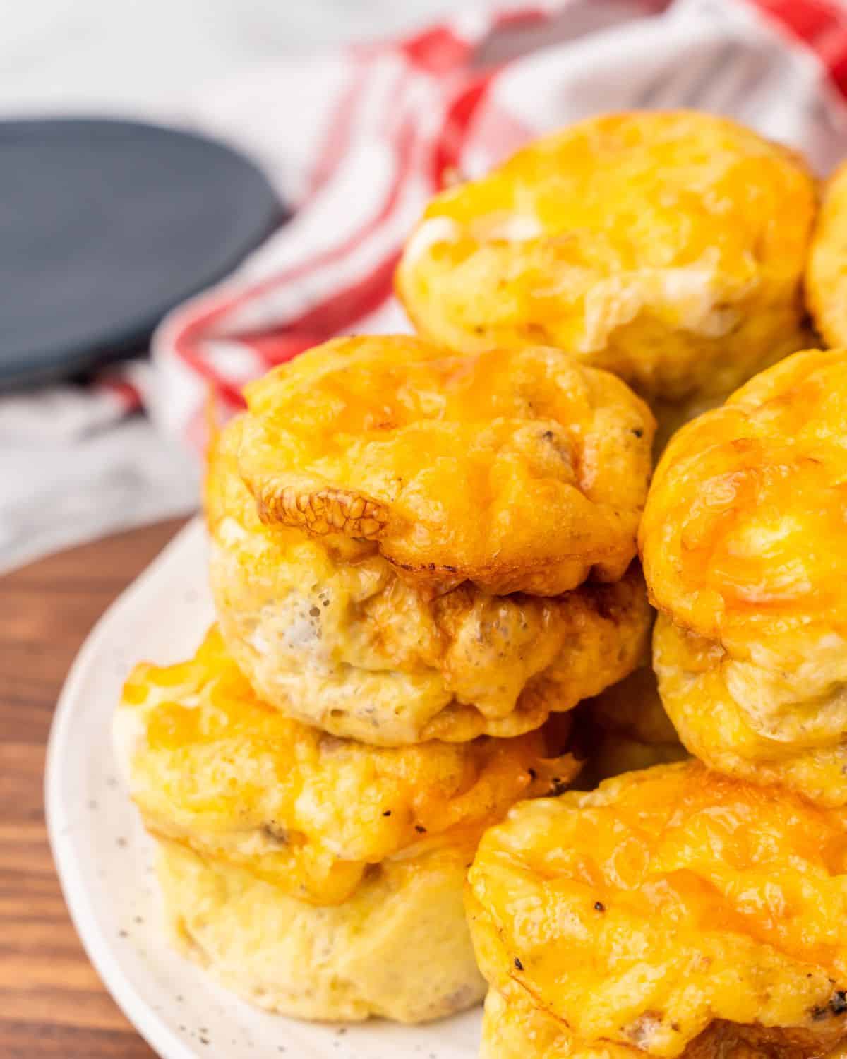 egg sausage cups stacked on a plate.