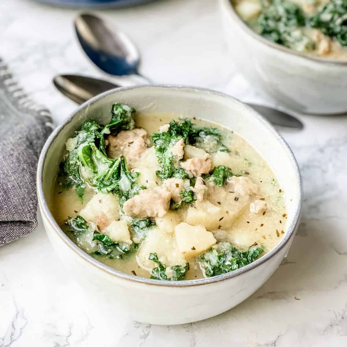 close up view of zuppa toscana in a bowl.