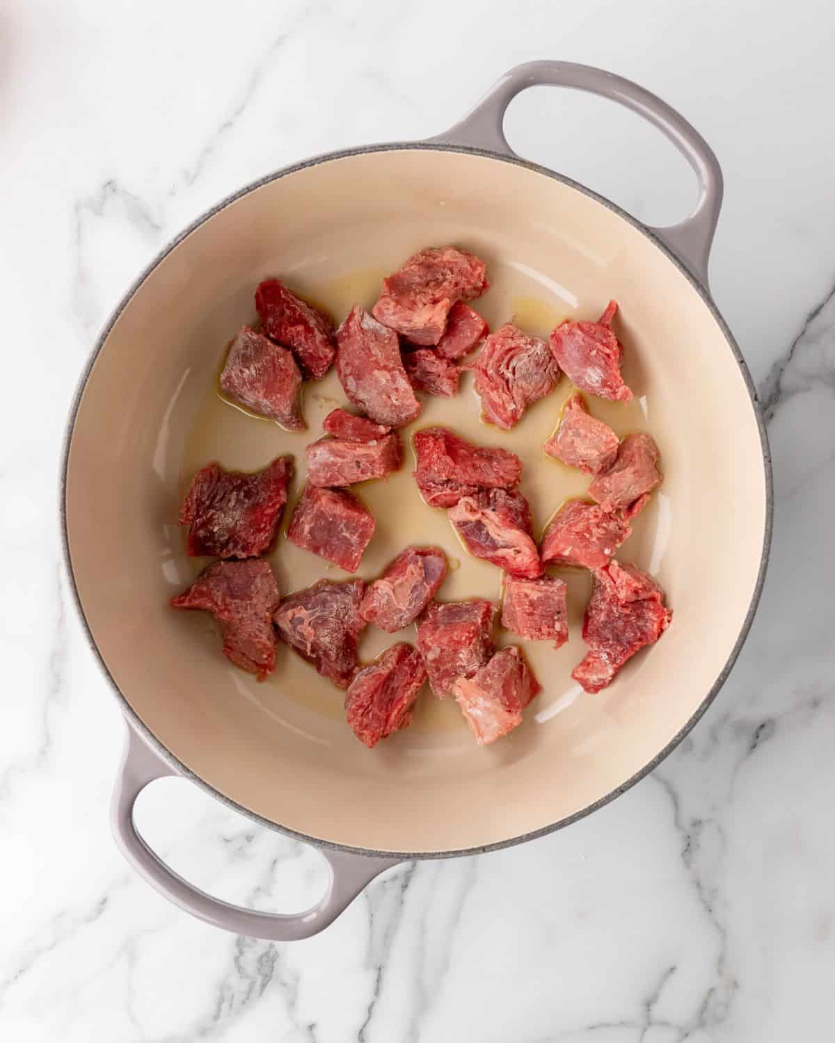 stew beef sautéed in oil in a dutch oven.