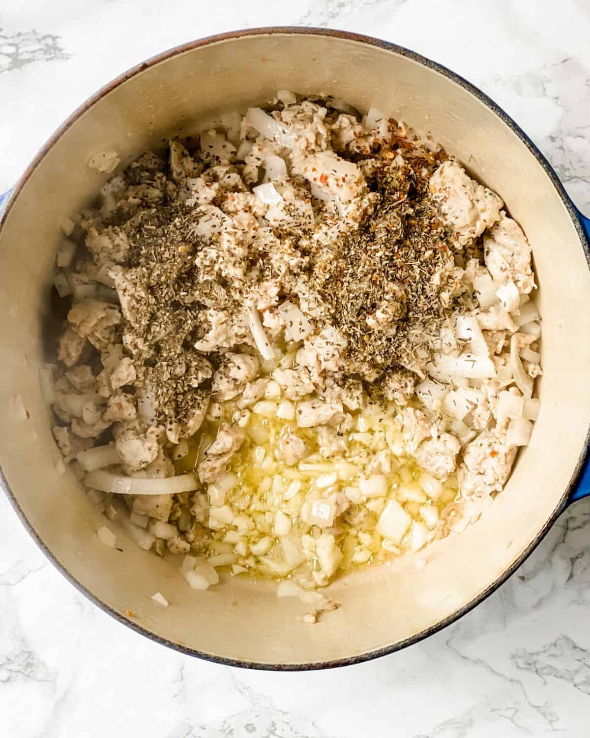 onions, garlic, and seasoning with the italian sausage in a soup pot.