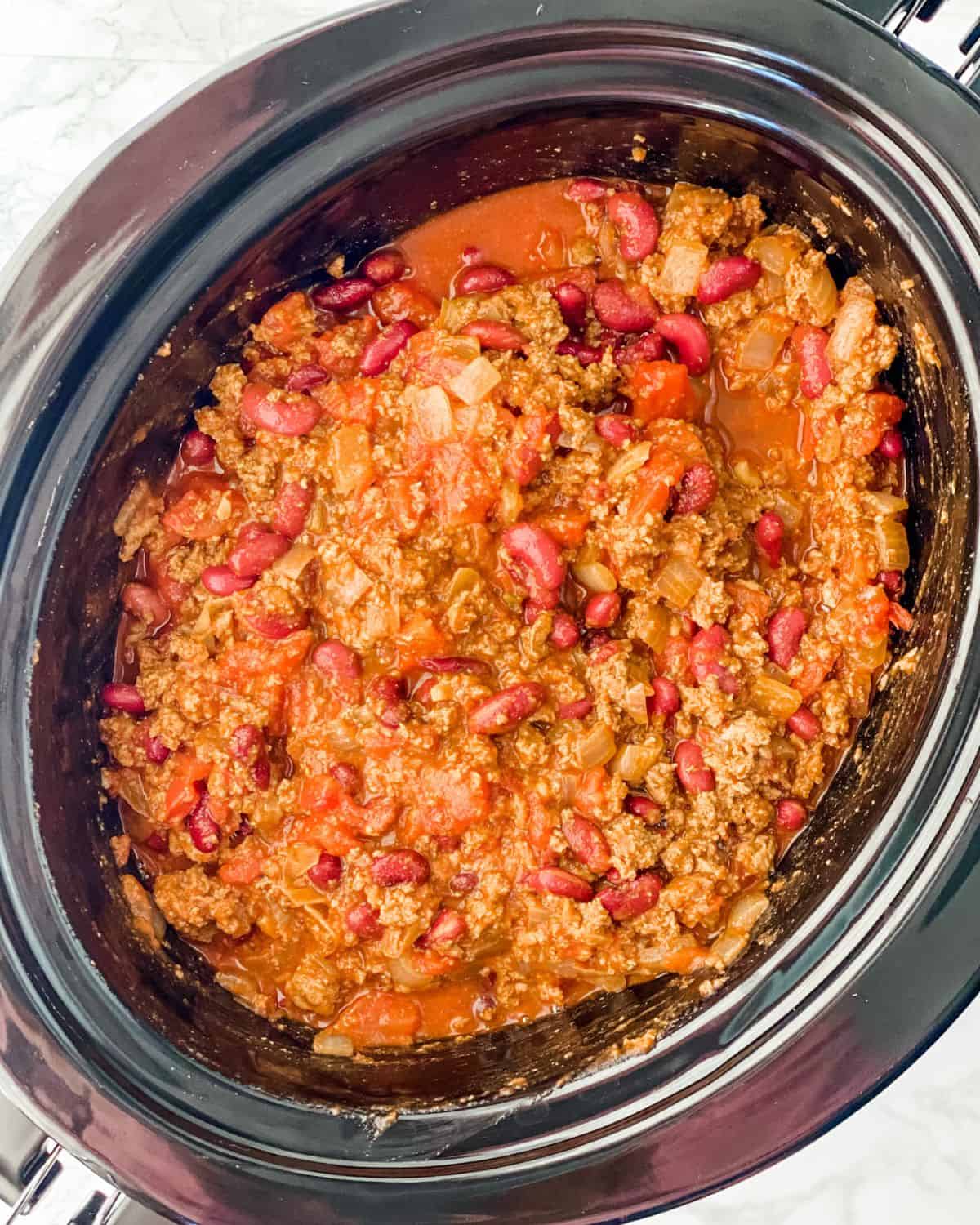 all of the ground turkey ingredients mixed int he slow cooker insert.