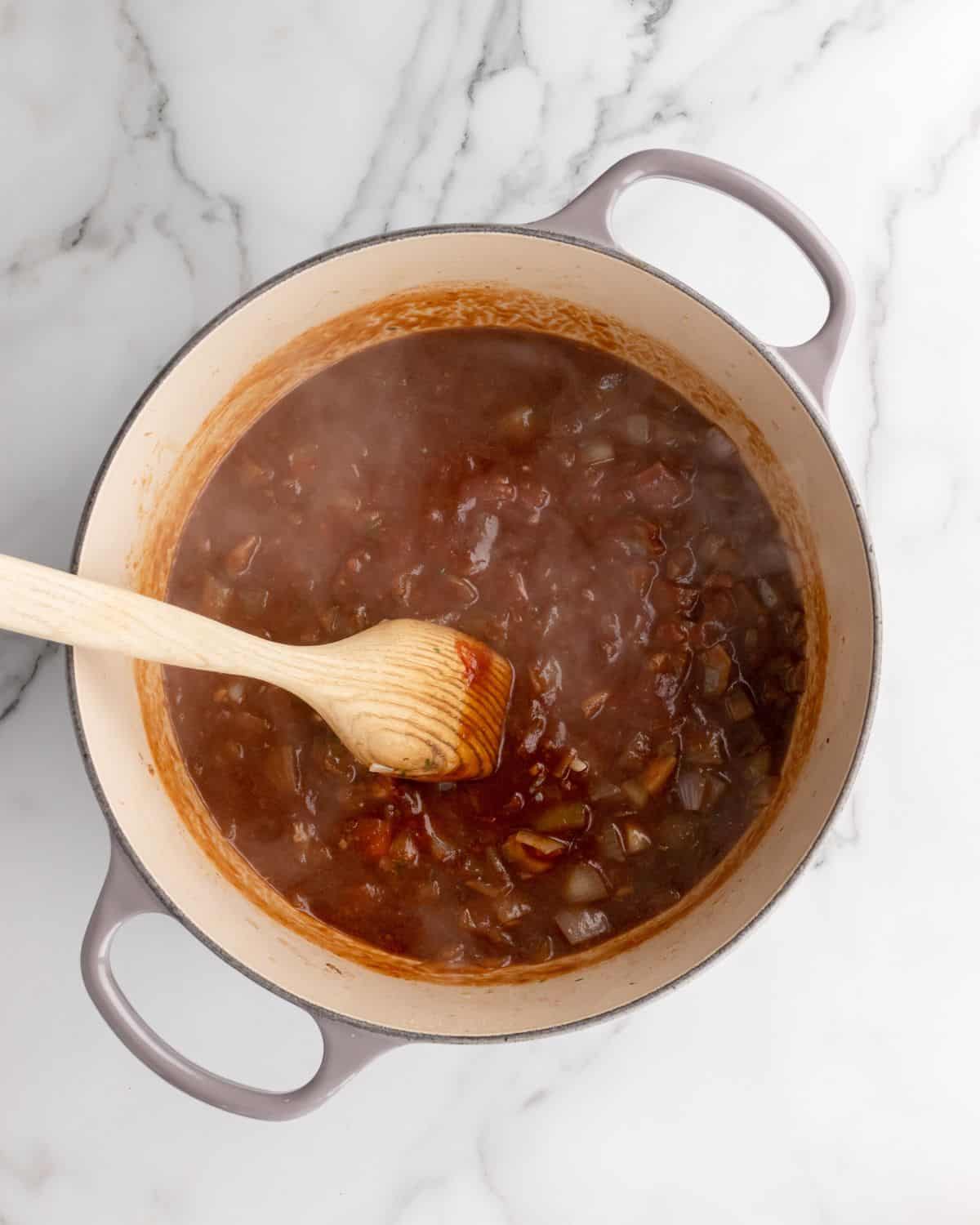 mix in the beef broth and tomato paste in with the beer.