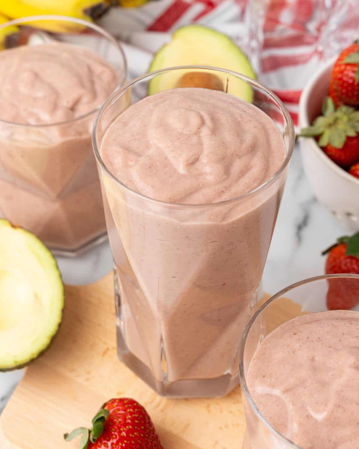 strawberry avocado smoothie in glasses.