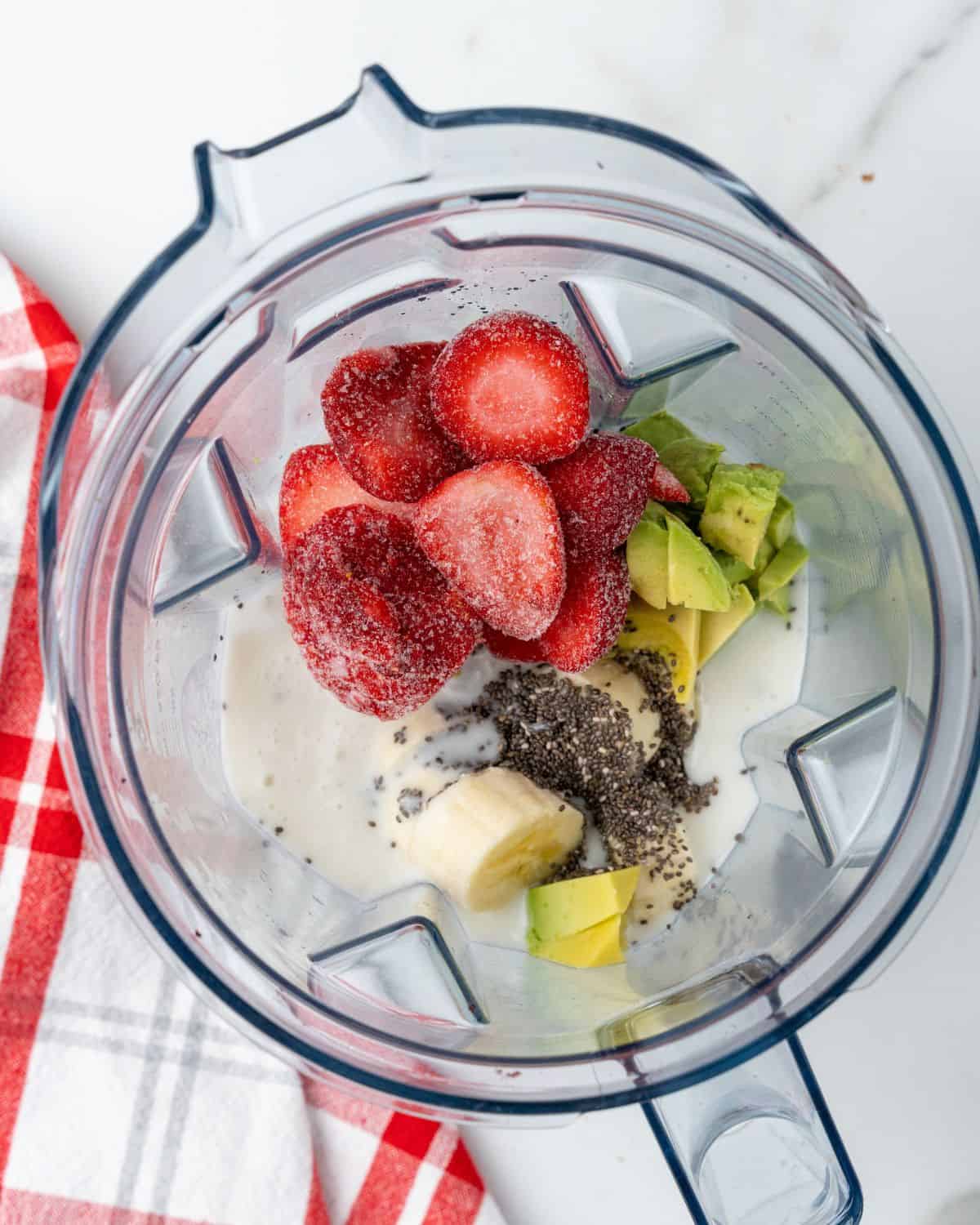 strawberry avocado ingredients in a blender.