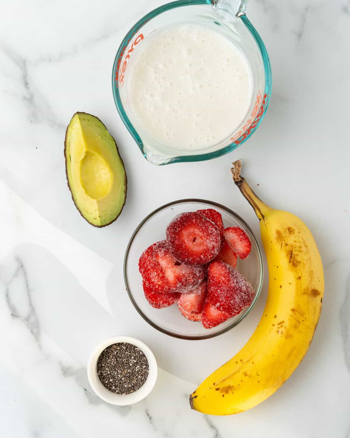 ingredients to make strawberry avocado banana smoothie.