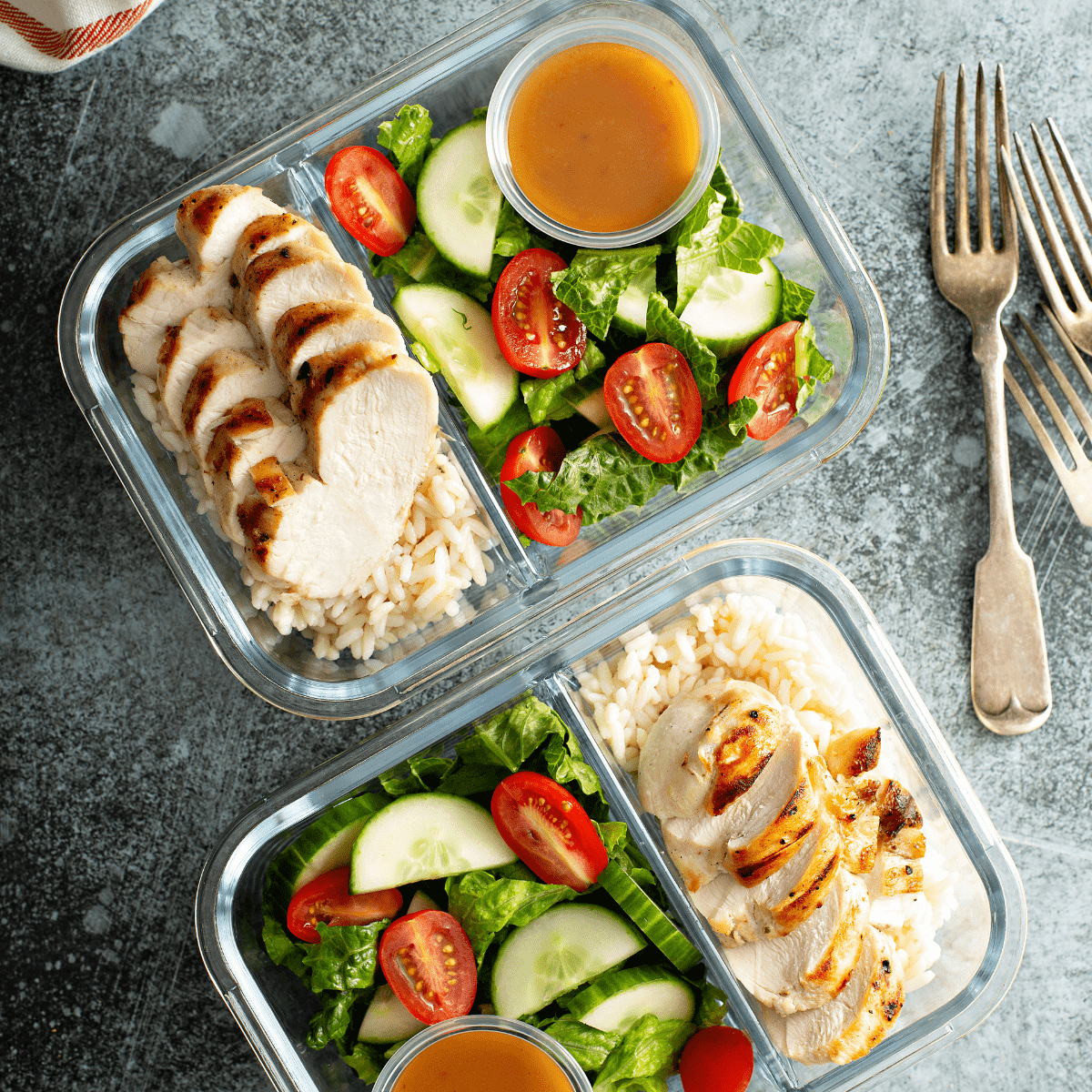 salad and chicken in meal prep container.