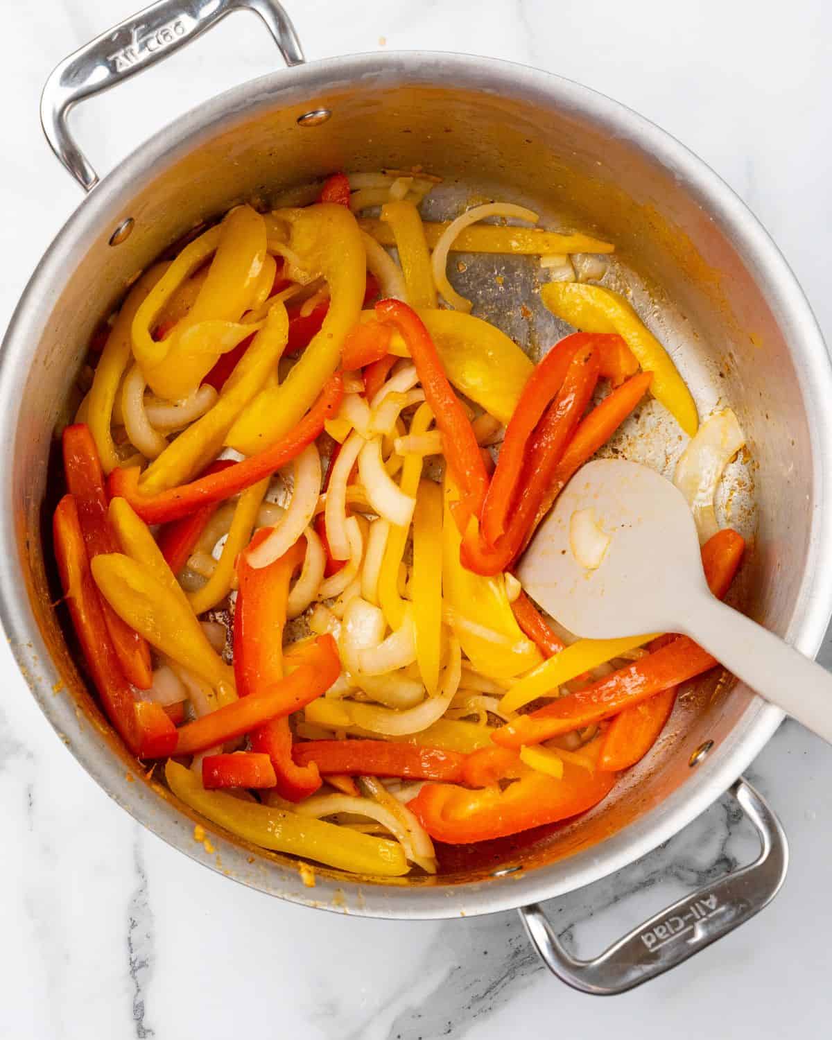 peppers and onions cooked in the pot.