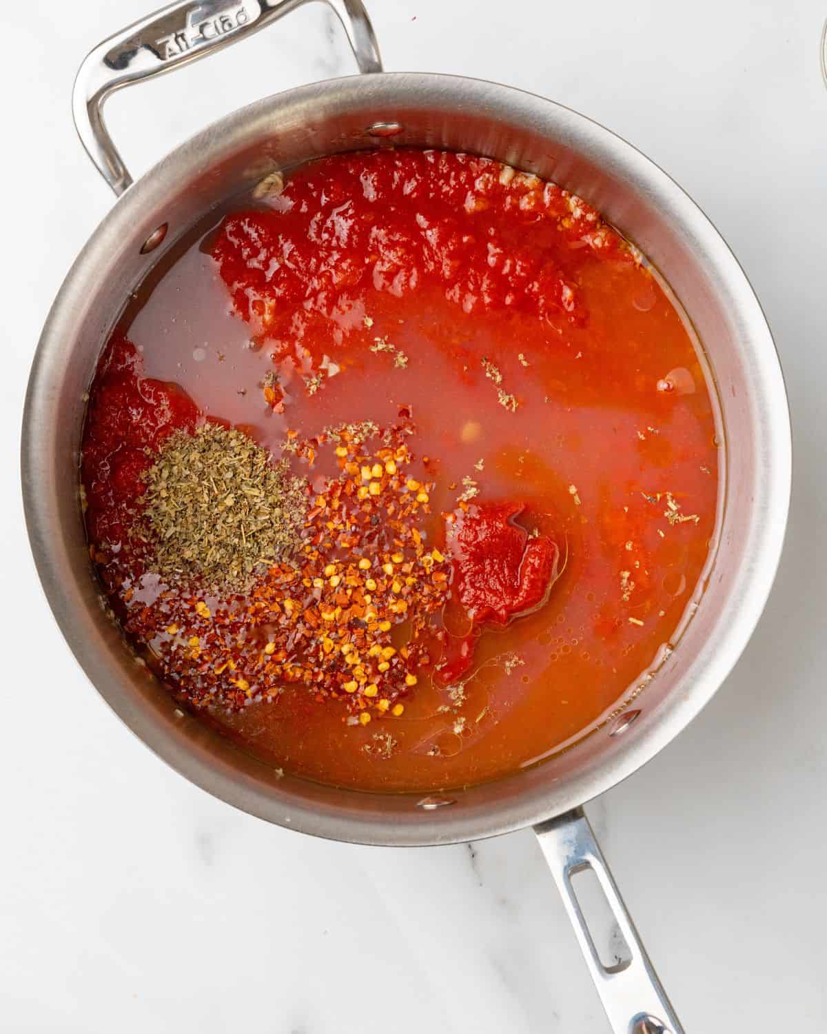 clam juice, tomatoes, and seasonings into the pan.