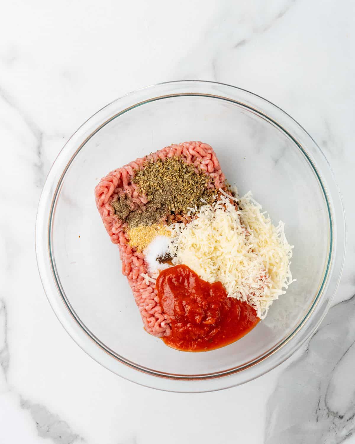 italian turkey burger ingredients into a bowl.