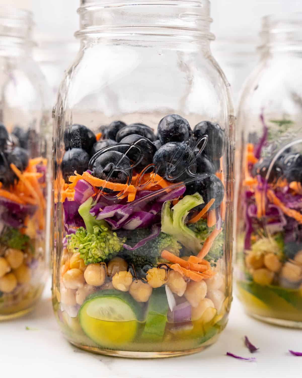 ingredients up to the blueberries in a mason jar.