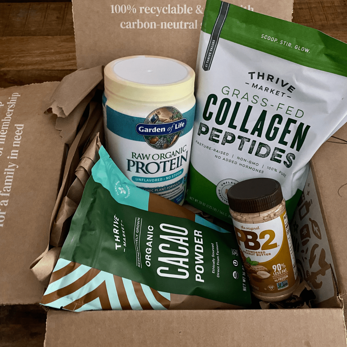 a thrive market box filled with smoothie ingredients including protein power and collagen powder.
