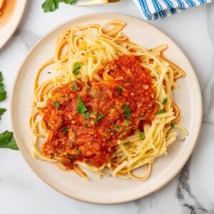 red clam sauce made with canned clams over linguine pasta.