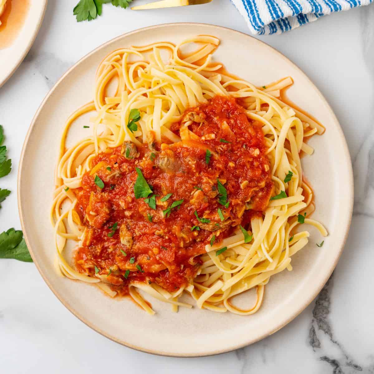 red clam sauce using canned clams over a bed of linguine.