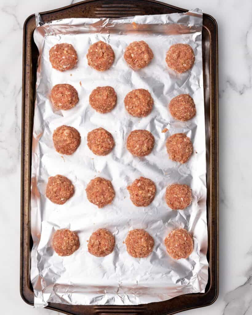 meatball rolled on and placed on a baking sheet.