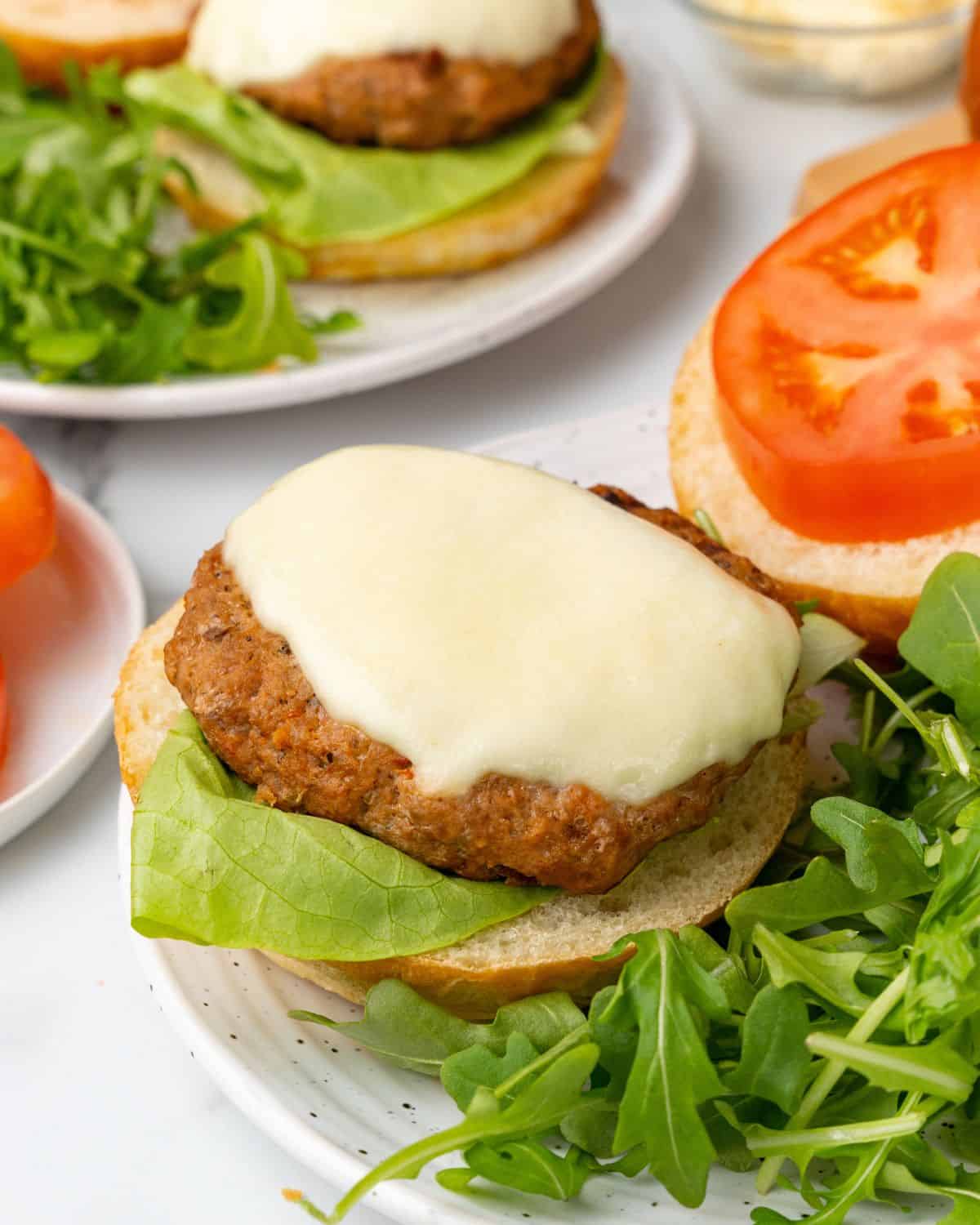 close-up view of a italian turkey burger on a bun.