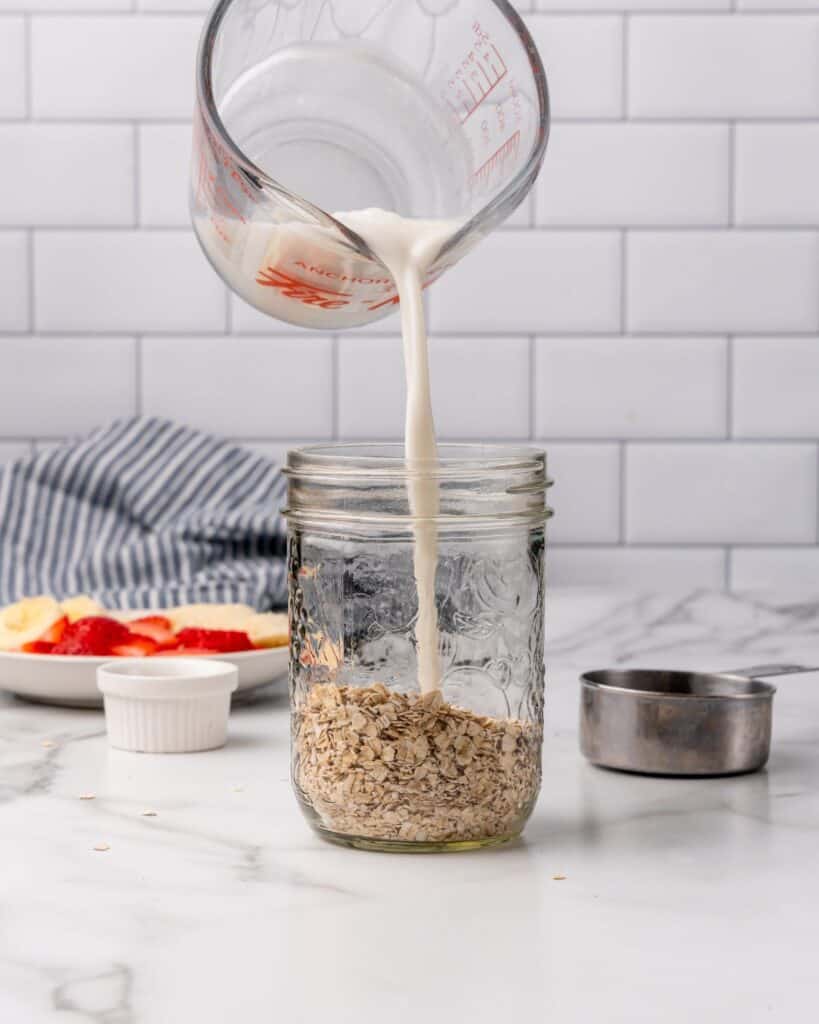 adding milk to jar.