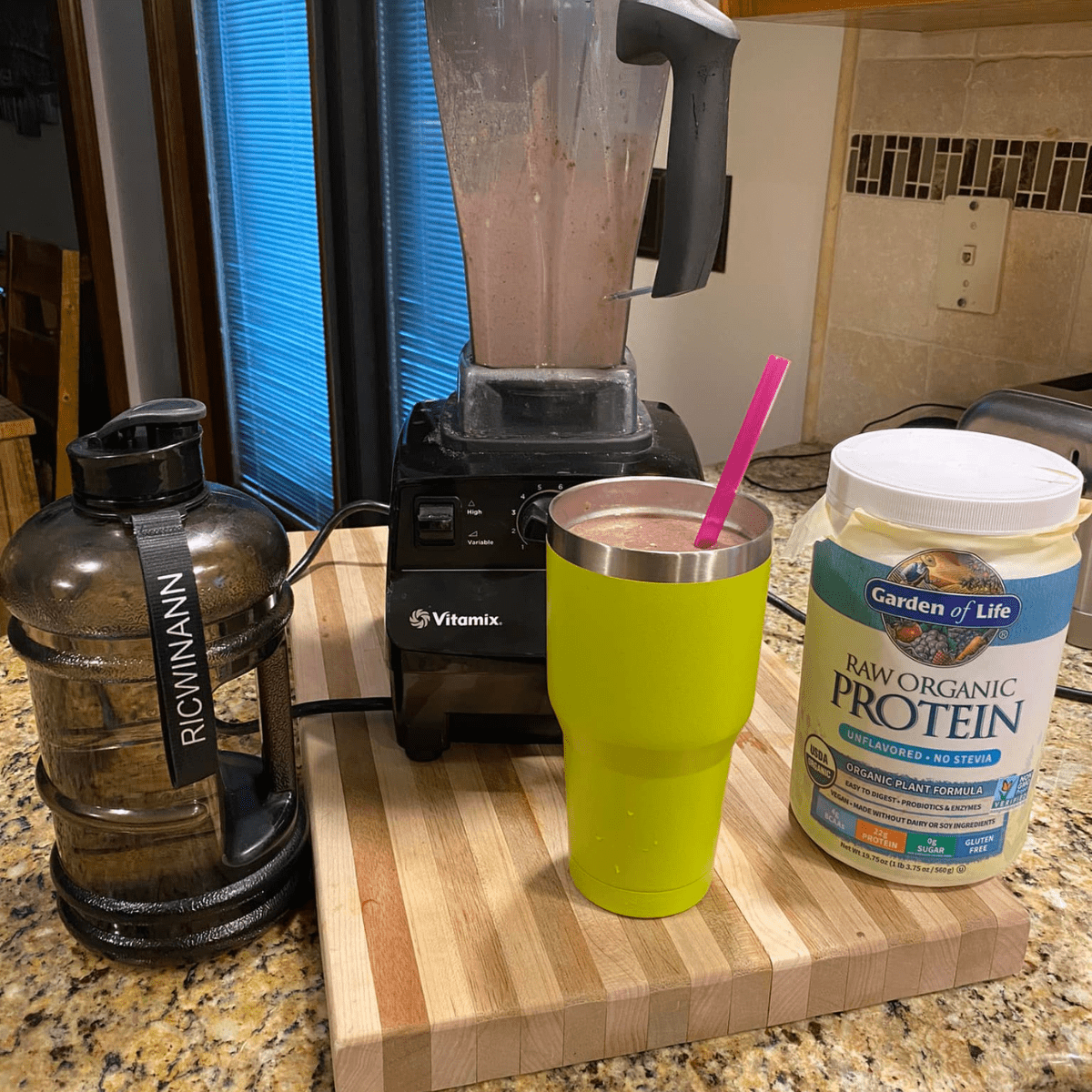 protein powder next to the smootie and blender.