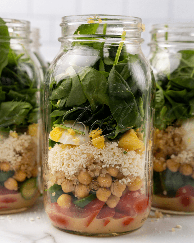 ingredients and spinach layered into a mason jar.