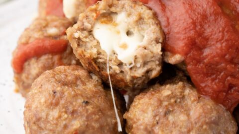 stuffed turkey meatballs on a plate with sauce.