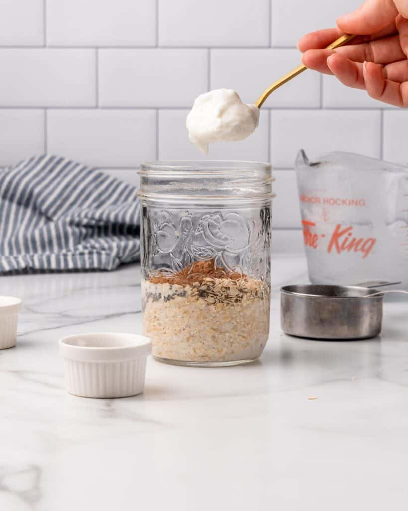 adding yogurt to jar