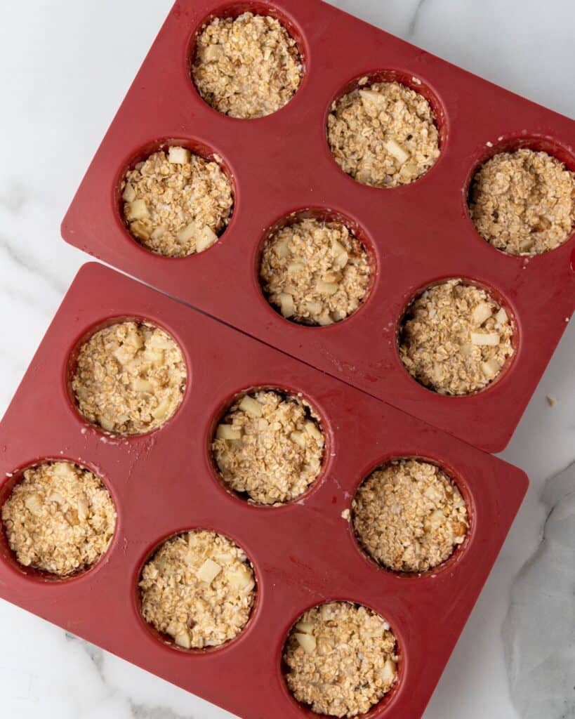 apple baked oatmeal batter in muffin pan.