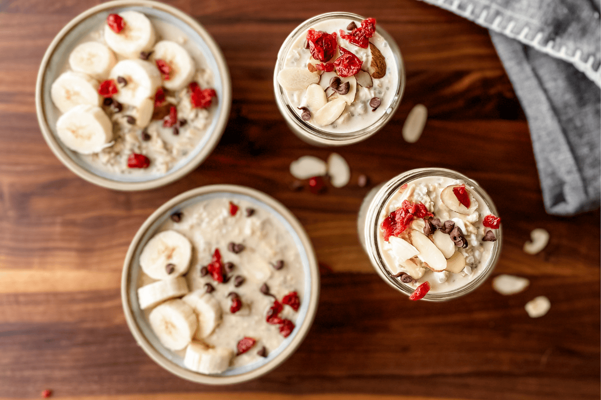 overhead view of protein overnight oats in bowl and jars